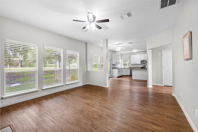 3327 Shady Glen Ln, Missouri City, TX 77459 - unfurnished living room with ceiling fan and dark wood-style floors
