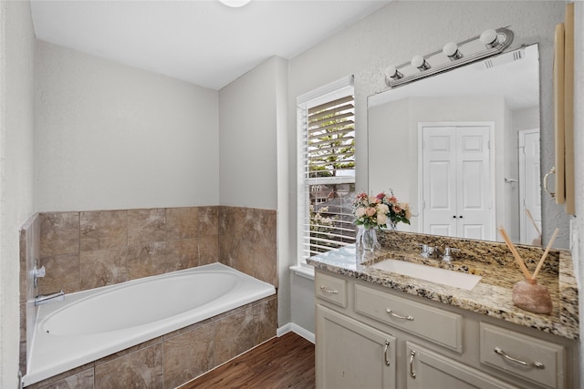 3327 Shady Glen Ln, Missouri City, TX 77459 - full bath featuring wood finished floors, a bath, and vanity