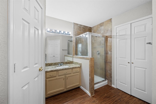 3327 Shady Glen Ln, Missouri City, TX 77459 - bathroom featuring a stall shower, vanity, wood finished floors, and a closet