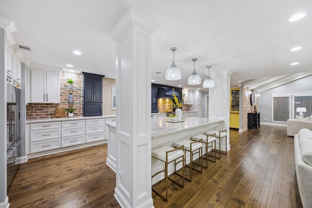 206 Lakemere St, Houston, TX 77079 - kitchen featuring decorative columns, tasteful backsplash, white cabinetry, dark wood-type flooring, and recessed lighting