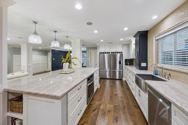 206 Lakemere St, Houston, TX 77079 - kitchen with stainless steel appliances, crown molding, dark wood-type flooring, a large island, and white cabinetry