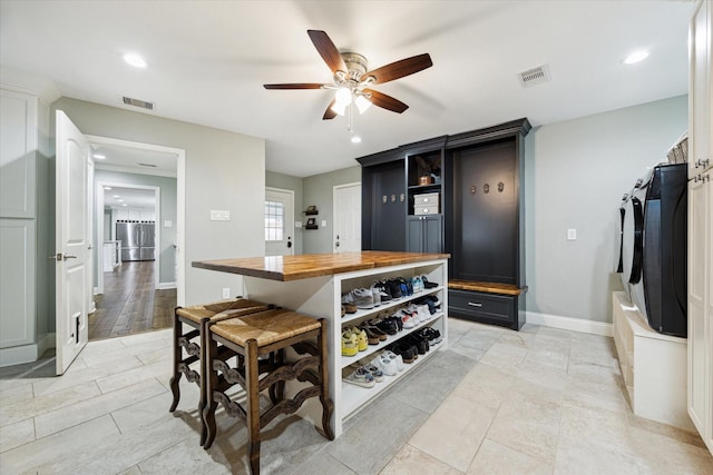 206 Lakemere St, Houston, TX 77079 - kitchen featuring butcher block countertops, ceiling fan, stainless steel refrigerator, independent washer and dryer, and recessed lighting