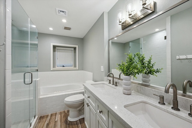 206 Lakemere St, Houston, TX 77079 - bathroom featuring wood finished floors, a garden tub, double vanity, a shower stall, and recessed lighting