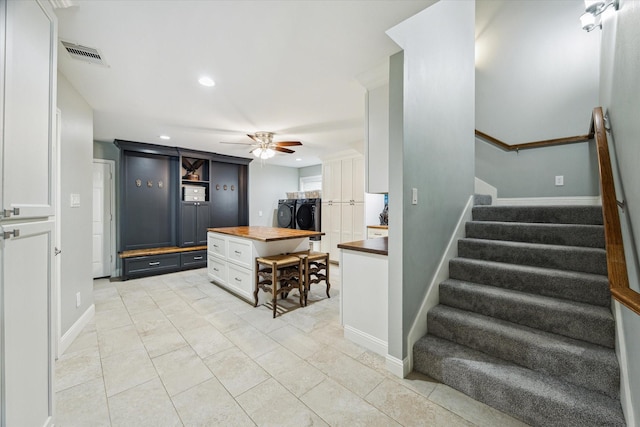 206 Lakemere St, Houston, TX 77079 - kitchen with wooden counters, separate washer and dryer, white cabinets, a ceiling fan, and recessed lighting