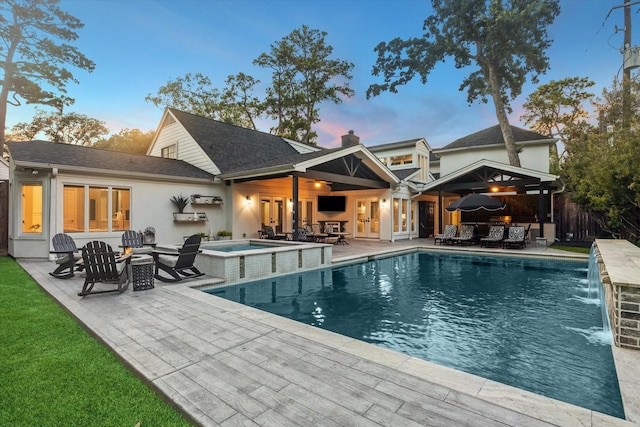 206 Lakemere St, Houston, TX 77079 - view of swimming pool featuring a patio area, a pool with connected hot tub, and an outdoor living space