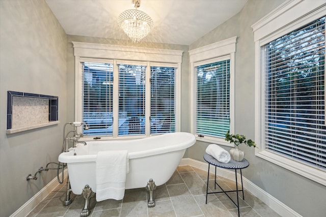 206 Lakemere St, Houston, TX 77079 - bathroom with a chandelier, a freestanding tub, healthy amount of natural light, lofted ceiling, and tile patterned floors