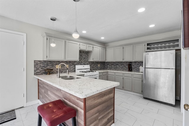 13530 Sharpbill Dr, Houston, TX 77083 - kitchen with freestanding refrigerator, gas range gas stove, light marble finish flooring, a peninsula, and tasteful backsplash