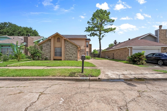 13530 Sharpbill Dr, Houston, TX 77083 - view of front facade featuring driveway, brick siding, an attached garage, and a front yard