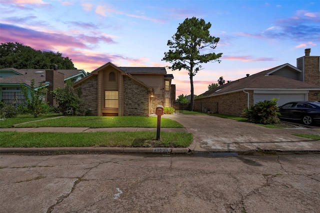 13530 Sharpbill Dr, Houston, TX 77083 - view of front of home featuring driveway, a garage, a front lawn, and brick siding