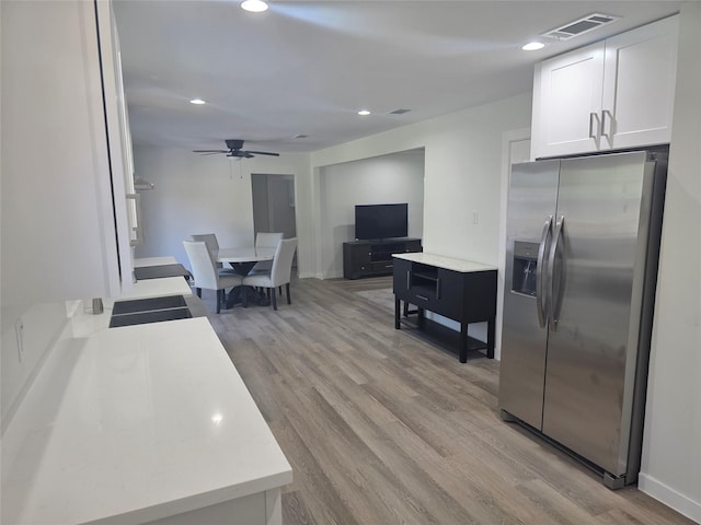 121 Tanglewood St, Baytown, TX 77520 - kitchen featuring stainless steel fridge, light wood-style flooring, ceiling fan, white cabinetry, and recessed lighting