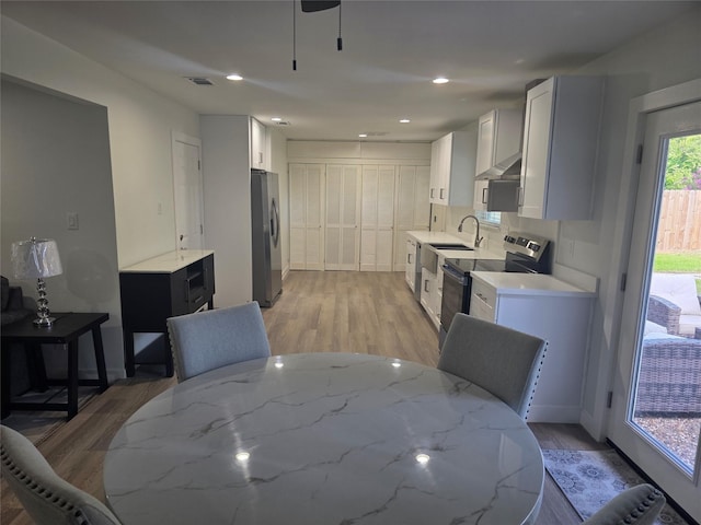 121 Tanglewood St, Baytown, TX 77520 - dining space with light wood-style flooring, recessed lighting, and a ceiling fan