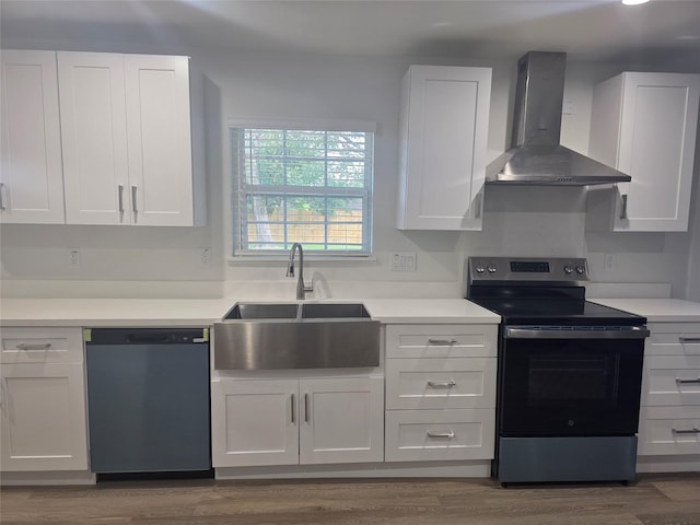 121 Tanglewood St, Baytown, TX 77520 - kitchen with stainless steel electric range, wall chimney exhaust hood, dishwashing machine, and white cabinetry