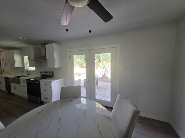 121 Tanglewood St, Baytown, TX 77520 - kitchen featuring electric range, wall chimney exhaust hood, dishwashing machine, french doors, and dark wood finished floors