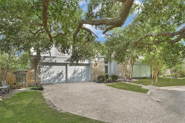 202 Old Bridge Lk, Houston, TX 77069 - view of property hidden behind natural elements featuring concrete driveway and a garage