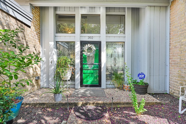 202 Old Bridge Lk, Houston, TX 77069 - doorway to property with brick siding and board and batten siding