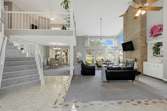 202 Old Bridge Lk, Houston, TX 77069 - carpeted living room featuring high vaulted ceiling, a chandelier, ceiling fan, stairway, and tile patterned flooring