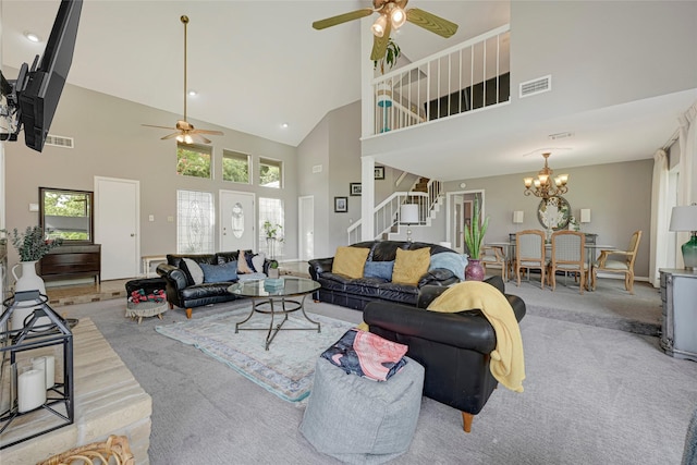 202 Old Bridge Lk, Houston, TX 77069 - living room featuring a ceiling fan, light colored carpet, high vaulted ceiling, stairway, and a chandelier