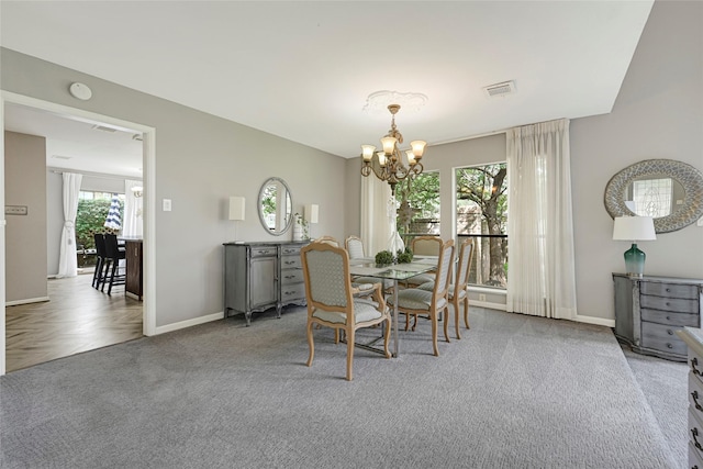 202 Old Bridge Lk, Houston, TX 77069 - carpeted dining room featuring a chandelier and baseboards