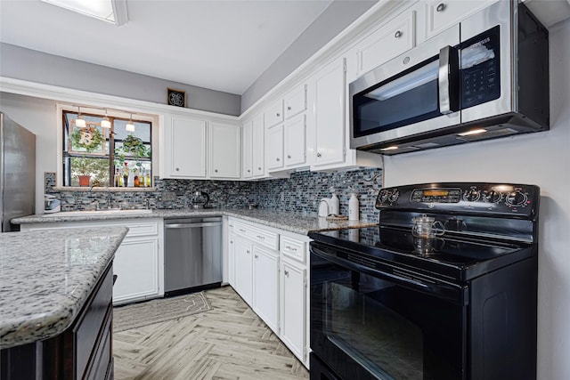 202 Old Bridge Lk, Houston, TX 77069 - kitchen featuring stainless steel appliances, white cabinets, tasteful backsplash, and light stone counters