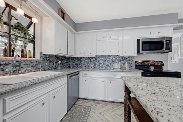 202 Old Bridge Lk, Houston, TX 77069 - kitchen with appliances with stainless steel finishes, white cabinets, backsplash, and light stone countertops