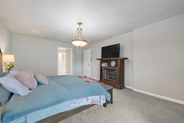 202 Old Bridge Lk, Houston, TX 77069 - bedroom with carpet, a glass covered fireplace, and a textured ceiling