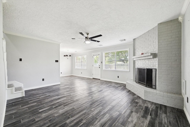 1804 Sleepy Creek Way, Pearland, TX 77581 - unfurnished living room featuring ceiling fan, dark wood finished floors, a fireplace, a textured ceiling, and crown molding