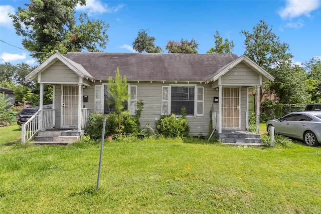 324 Erin, Houston, TX 77009 - bungalow with a front yard and a shingled roof