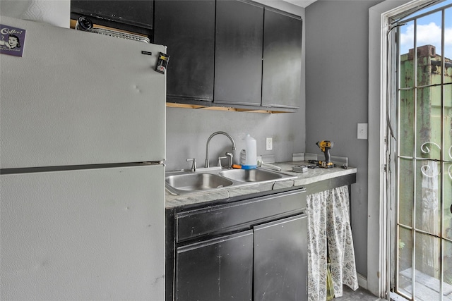 324 Erin, Houston, TX 77009 - kitchen with freestanding refrigerator, dark cabinetry, and light countertops