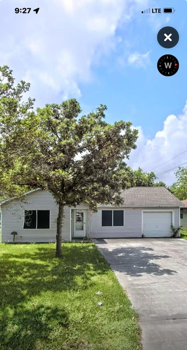 308 S 11th St, La Porte, TX 77571 - view of front of house featuring concrete driveway, a front yard, and a garage