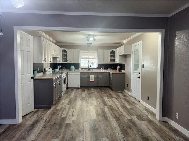 308 S 11th St, La Porte, TX 77571 - kitchen featuring white appliances, dark wood-style floors, crown molding, glass insert cabinets, and gray cabinetry