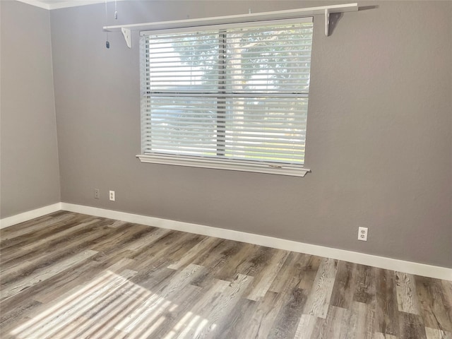 308 S 11th St, La Porte, TX 77571 - spare room featuring healthy amount of natural light and wood finished floors
