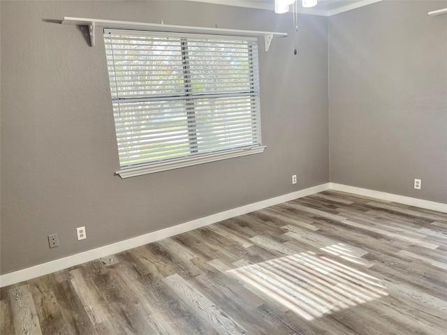 308 S 11th St, La Porte, TX 77571 - empty room with wood finished floors, ornamental molding, and ceiling fan