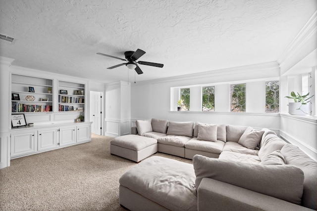 16235 Salmon Ln, Spring, TX 77379 - living area featuring crown molding, a textured ceiling, ceiling fan, light colored carpet, and built in features