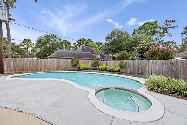 16235 Salmon Ln, Spring, TX 77379 - view of swimming pool featuring a pool with connected hot tub, a fenced backyard, and a patio area