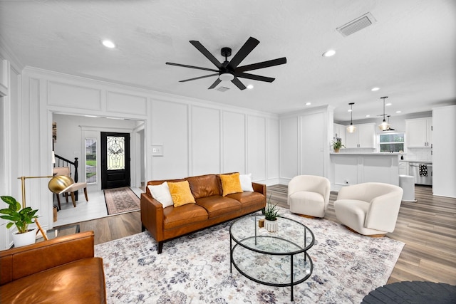 16235 Salmon Ln, Spring, TX 77379 - living room featuring a decorative wall, a ceiling fan, wood finished floors, recessed lighting, and ornamental molding