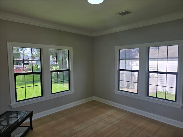 604 N Main St, Galena Park, TX 77547 - spare room with healthy amount of natural light, wood finished floors, and crown molding