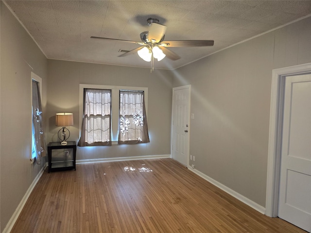 604 N Main St, Galena Park, TX 77547 - empty room featuring a ceiling fan, wood-type flooring, and ornamental molding