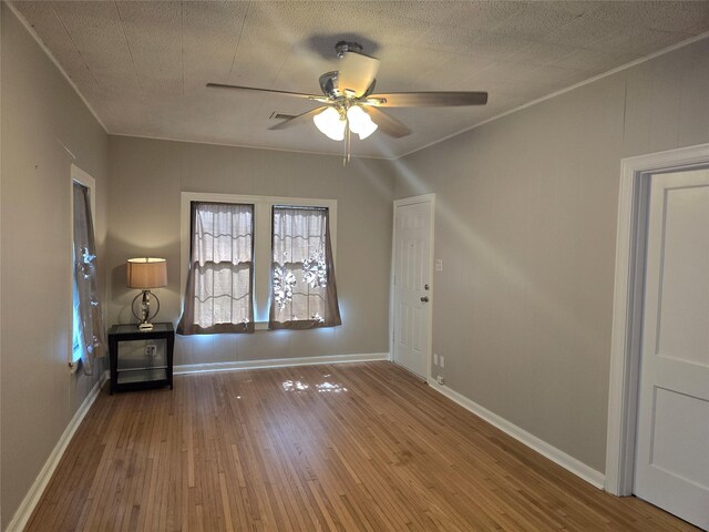 604 N Main St, Galena Park, TX 77547 - empty room featuring a ceiling fan, wood-type flooring, and ornamental molding