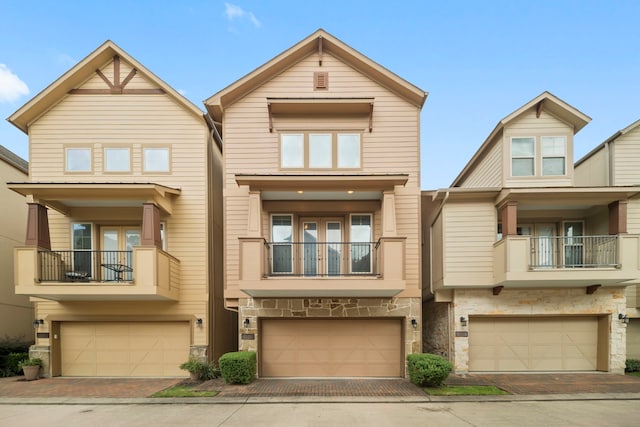 2623 Shady Woods Ln, Houston, TX 77008 - view of front of home with a garage, stone siding, a balcony, and decorative driveway