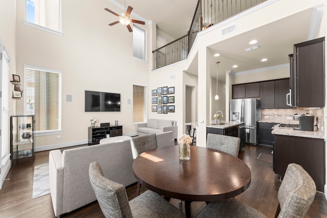 2623 Shady Woods Ln, Houston, TX 77008 - dining area with a high ceiling, ceiling fan, dark wood finished floors, and crown molding