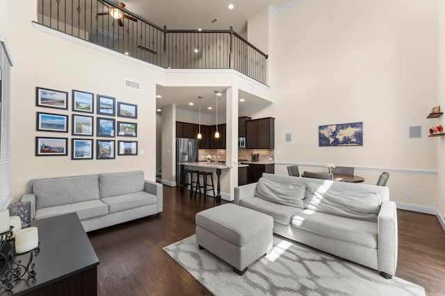 2623 Shady Woods Ln, Houston, TX 77008 - living room featuring dark wood-style flooring, a high ceiling, and recessed lighting