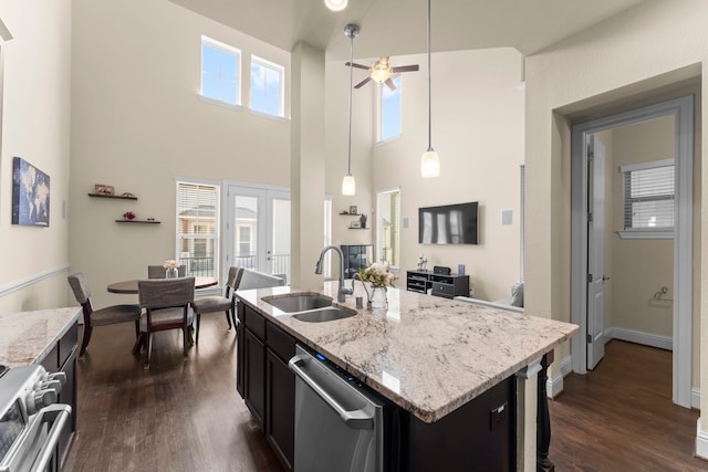 2623 Shady Woods Ln, Houston, TX 77008 - kitchen featuring stainless steel dishwasher, a ceiling fan, dark wood-type flooring, stove, and dark cabinetry