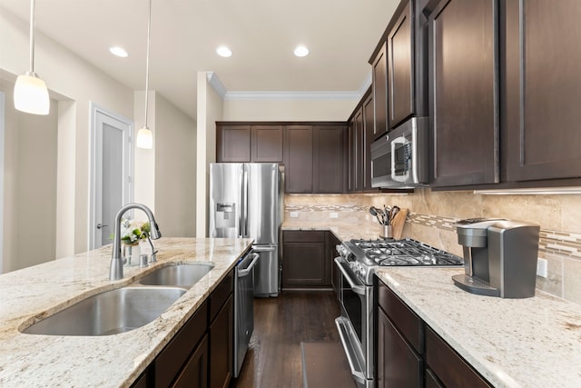 2623 Shady Woods Ln, Houston, TX 77008 - kitchen with appliances with stainless steel finishes, dark brown cabinetry, crown molding, light stone counters, and decorative light fixtures
