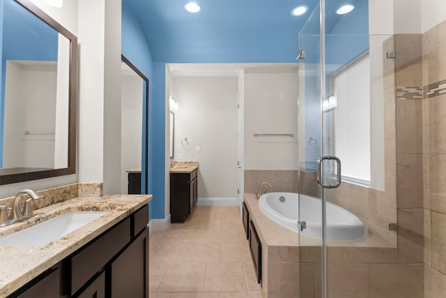2623 Shady Woods Ln, Houston, TX 77008 - bathroom with a shower stall, a garden tub, two vanities, recessed lighting, and tile patterned floors