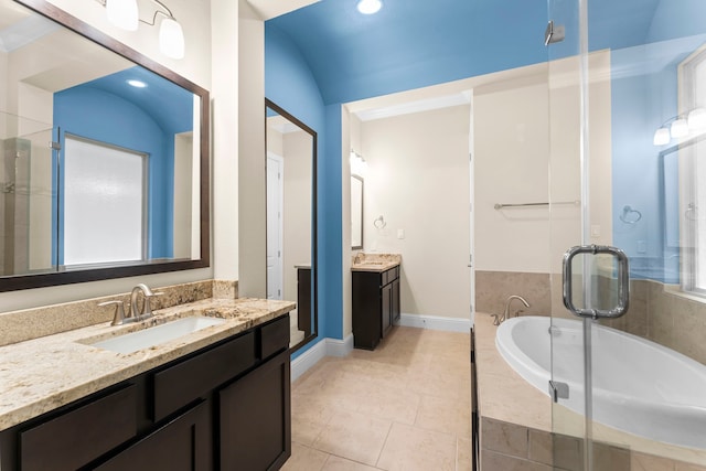2623 Shady Woods Ln, Houston, TX 77008 - bathroom featuring two vanities, a bath, a shower stall, and tile patterned floors