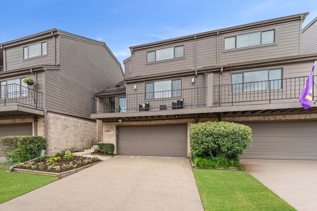 2816 Lighthouse Dr, Houston, TX 77058 - view of front of home featuring a balcony, driveway, a garage, and brick siding
