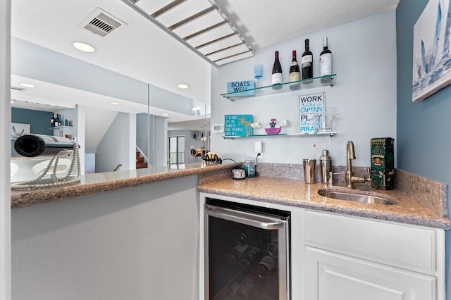 2816 Lighthouse Dr, Houston, TX 77058 - indoor wet bar with beverage cooler, stairs, and recessed lighting