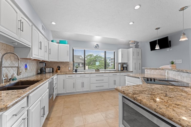 2816 Lighthouse Dr, Houston, TX 77058 - kitchen with backsplash, white cabinets, light stone counters, decorative light fixtures, and light tile patterned flooring