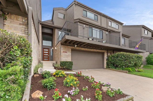 2816 Lighthouse Dr, Houston, TX 77058 - view of front facade featuring a balcony, an attached garage, brick siding, and concrete driveway
