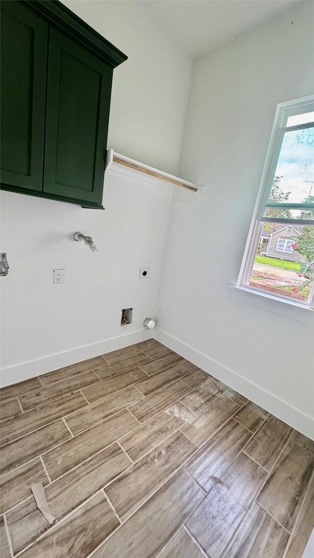 2418 Centennial St, Liberty, TX 77575 - laundry room featuring cabinet space, wood finished floors, and hookup for an electric dryer